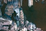 LU-257.688, Individual in cave stalagmites and stalactites