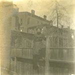 LU-083.1758 - Unknown woman sitting on top of fence. Circa early 1900s