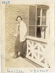 LU-387.002, Woman standing on elevated breezeway railing. Inscribed on top margin, "1919" and on bottom margin, "LITTLE STOVER." Likely, Julia Holladay Stover. by Katherine Krebs